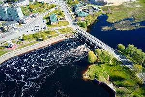 Small town landscape with bridge over river, aerial view. photo