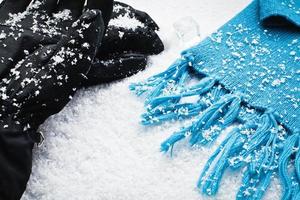 Gloves and a scarf over the snow photo