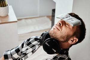 Man sleep with dollar bills photo