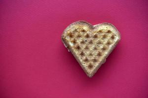 Waffle hearts on a red background. Valentine's day. Confectionery products in the form of a heart. photo