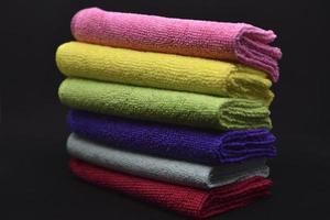 Multicolored rags in a pile. A bunch of colored towels. Terry towels. A cleaning cloth. photo