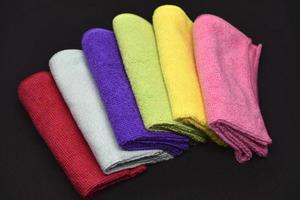 Multicolored rags in a pile. A bunch of colored towels. Terry towels. A cleaning cloth. photo