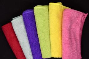 Multicolored rags in a pile. A bunch of colored towels. Terry towels. A cleaning cloth. photo