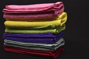 Multicolored rags in a pile. A bunch of colored towels. Terry towels. A cleaning cloth. photo