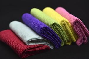 Multicolored rags in a pile. A bunch of colored towels. Terry towels. A cleaning cloth. photo