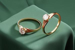 Pareja de oro anillos de diamantes representación 3d colocados en tela verde foto