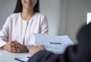 Executives are interviewing candidates. Focusing on resume writing tips, applicant qualifications, interview skills and pre-interview preparation. Considerations for new employees photo