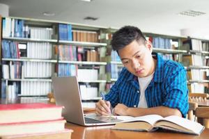 Men use laptops and learn online in the school library. It is a modern education. photo