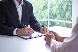 Executives are interviewing candidates. Focusing on resume writing tips, applicant qualifications, interview skills and pre-interview preparation. Considerations for new employees photo