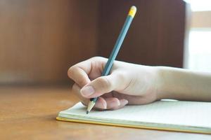 Woman's hand is writing photo