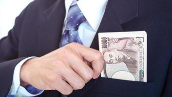 The hand of a business man catching money in a suit bag . Investment guidelines for business profits. photo