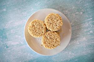 instant noodles on white plate, raw instant noodles circle for cooking food photo