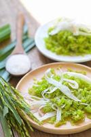 Thai dessert - pounded unripe rice food rice flakes cereal with coconut and sugar, Green rice sweet with ears of rice pandan leaf, Food dessert or snacks - Khao Mao name in Thailand photo
