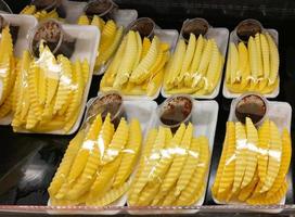 Slice mango fruit in plastic tray for sale in the market photo