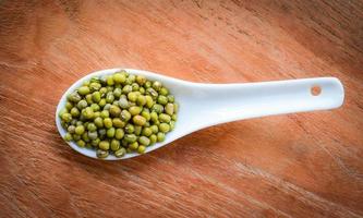 Mung beans or Green beans seed cereal whole grains on white spoon and wooden photo