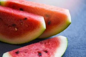 Close up of slice watermelon fruit on dark background photo
