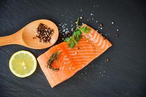 Fresh salmon fillet on dark background photo