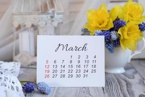 March calendar and spring flowers photo