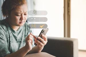 woman use smartphone give unhappy client with Sadness Emotion Face. Customer Experience dissatisfied Concept, bad service dislike bad quality, low rating, Bad review, social media not good. photo