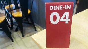 un número de orden 04 en la mesa. cenar en señal. en espera de señal de pedido en un restaurante o cafetería. foto