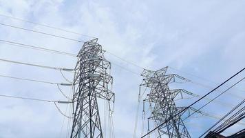 High voltage post or High voltage tower. High voltage power lines. Clear blue sky. photo