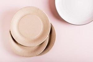 The concept of choosing between paper disposable plates and ceramic ones. Zero waste. Top view. photo