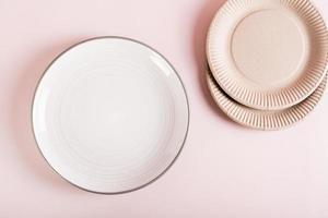 Choice between ceramic and paper disposable plates. Zero waste. Top view. photo