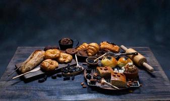 top view fresh bread brown  raisins sesame bakery made from wheat flour food homemade suitable for healthy eating on wooden table floor black rustic dark background photo