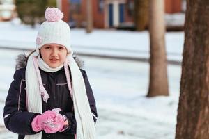 Adorable little girl having fun on winter day photo