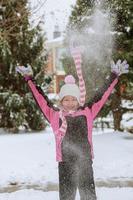 Adorable little girl having fun on winter day photo