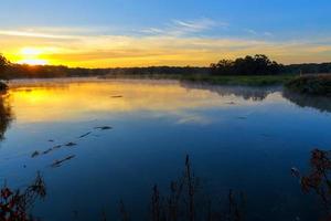 Misty morning on a small lake photo