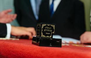 Hand of boy reading the Jewish Torah at Bar Mitzvah photo