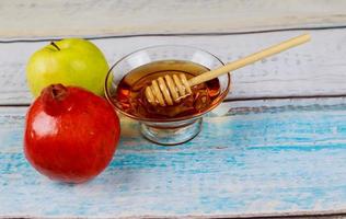 Pomegranate, apple and honey, traditional food of jewish New Year celebration, Rosh Hashana. photo