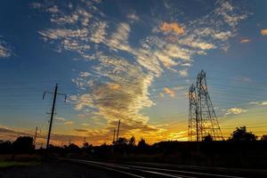 High voltage power pylons in sunset scene twilight photo