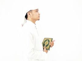 Man Holding and reading quran. Islamic Background photo