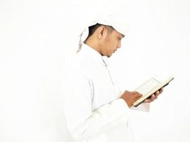 Man Holding and reading quran. Islamic Background photo