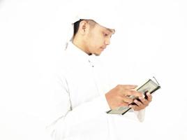 Man Holding and reading quran. Islamic Background photo