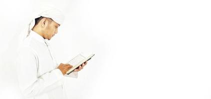 Man Holding and reading quran. Islamic Background photo