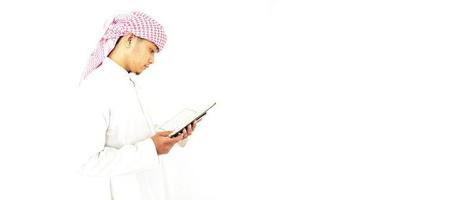 Man Holding and reading quran. Islamic Background photo