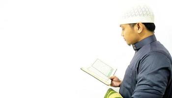 Man Holding and reading quran. Islamic Background photo