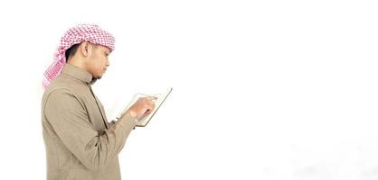 Man Holding and reading quran. Islamic Background photo