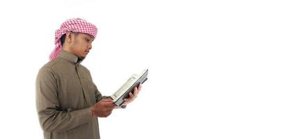 Man Holding and reading quran. Islamic Background photo