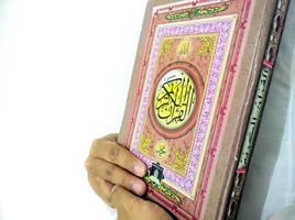 Man Holding and reading quran. Islamic Background photo