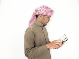 Man Holding and reading quran. Islamic Background photo