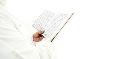 Man Holding and reading quran. Islamic Background photo