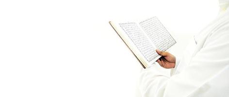 Man Holding and reading quran. Islamic Background photo