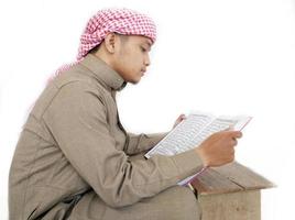 Man Holding and reading quran. Islamic Background photo