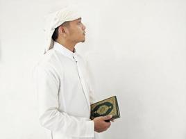 Man Holding and reading quran. Islamic Background photo