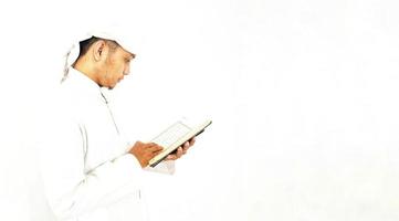 Man Holding and reading quran. Islamic Background photo