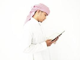 Man Holding and reading quran. Islamic Background photo